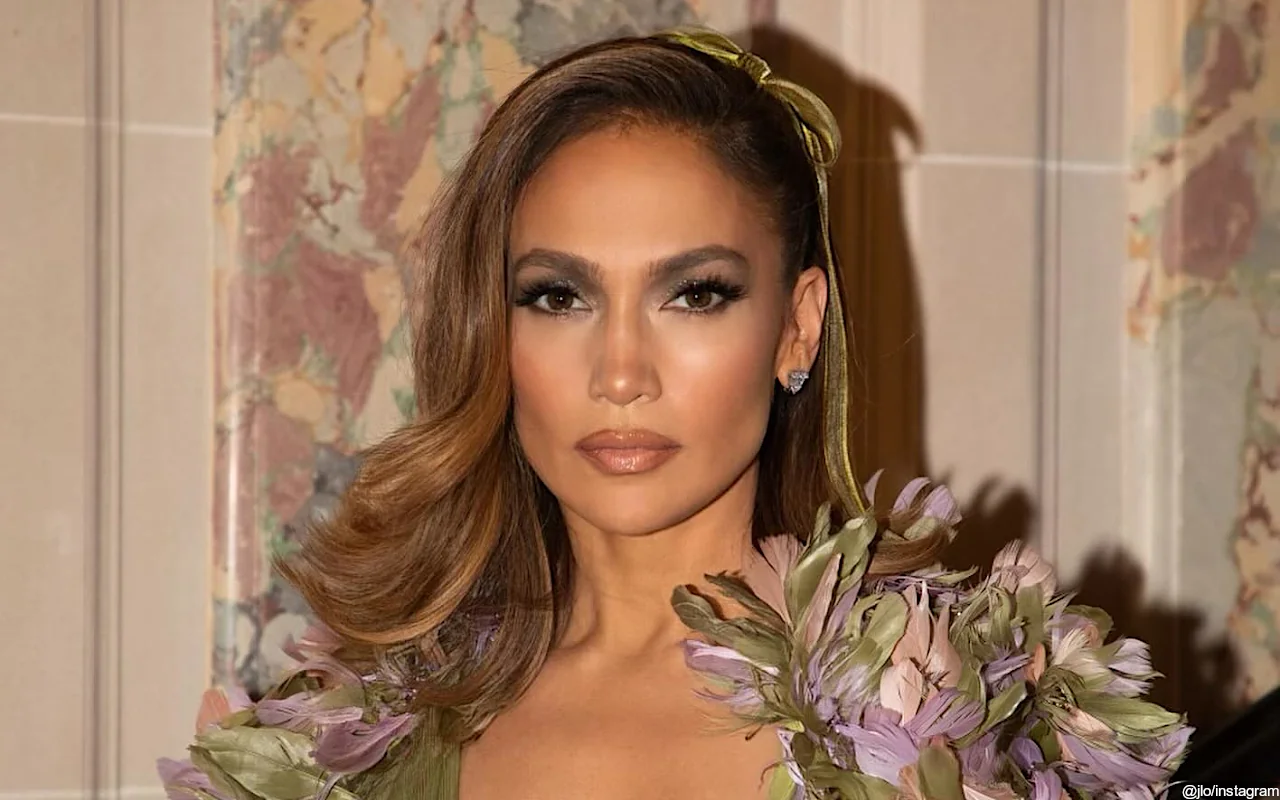 Jennifer Lopez Turns Heads in Dreamy Floral Cape Over Low-Cut Gown at Paris Fashion Week