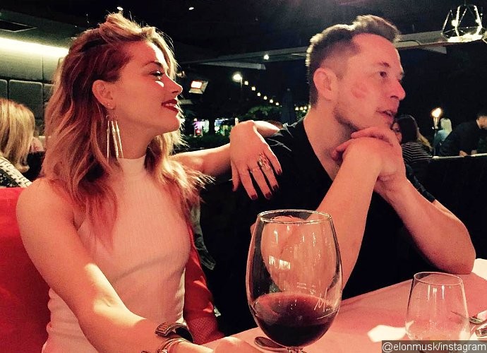 Amber Heard and Elon Musk Have Been a Couple for 'a While,' and He 'Is Very Attentive' to Her