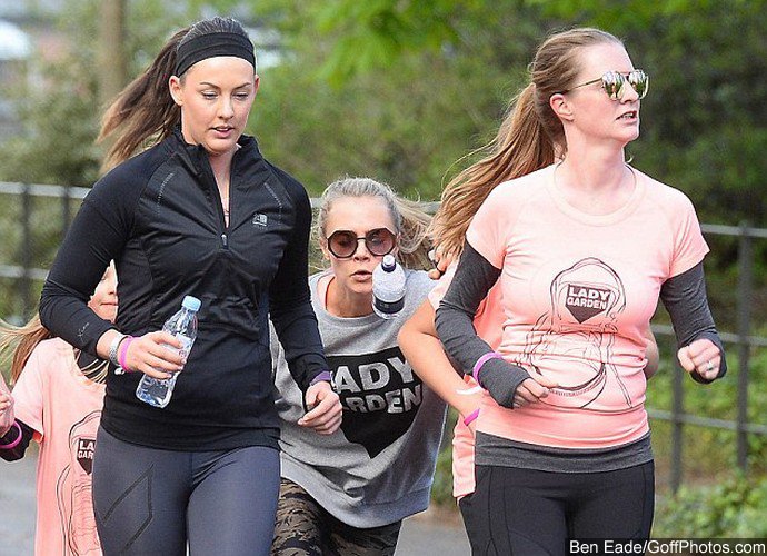 Cara Delevingne Takes Tumble During Charity Run With Sister Chloe in London