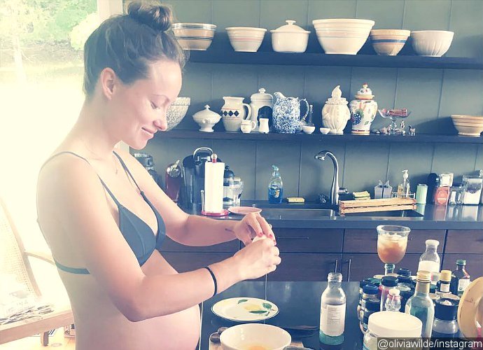 Olivia Wilde Bares Burgeoning Baby Bump While Cooking in Tiny Bra