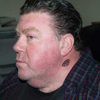 George Wendt, as MR. FLYNN, bearing the mark of the Bryans