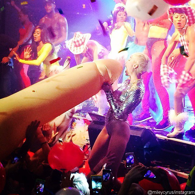 Video: Miley Cyrus Straddles a Giant Inflatable Penis Onstage During London Gig