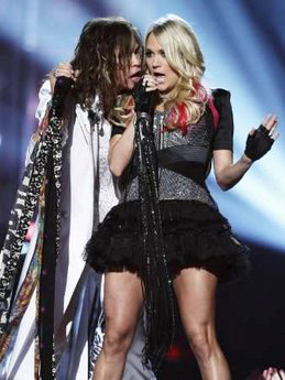 Video: Carrie Underwood and Steven Tyler Kiss on ACM Awards Stage