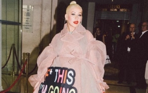 Christina Aguilera Puts on Sweary Oversized Trenchcoat for Paris Couture Week