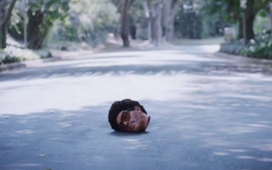 The Weeknd's Severed Head Charms Strangers in Bloody 'Too Late' Music Video