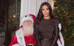 Kim Kardashian Sits on Santa's Lap at Kardashian Christmas Eve Party