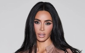 Kim Kardashian Decorates Her Black Scooter While Attending Christmas Party