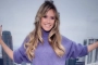 Heidi Klum Barely Covers Chest With Fur Coat in New Video