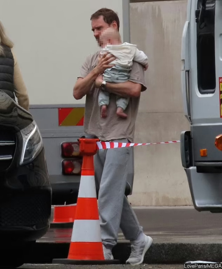 Michael Fassbender Cradling a Baby