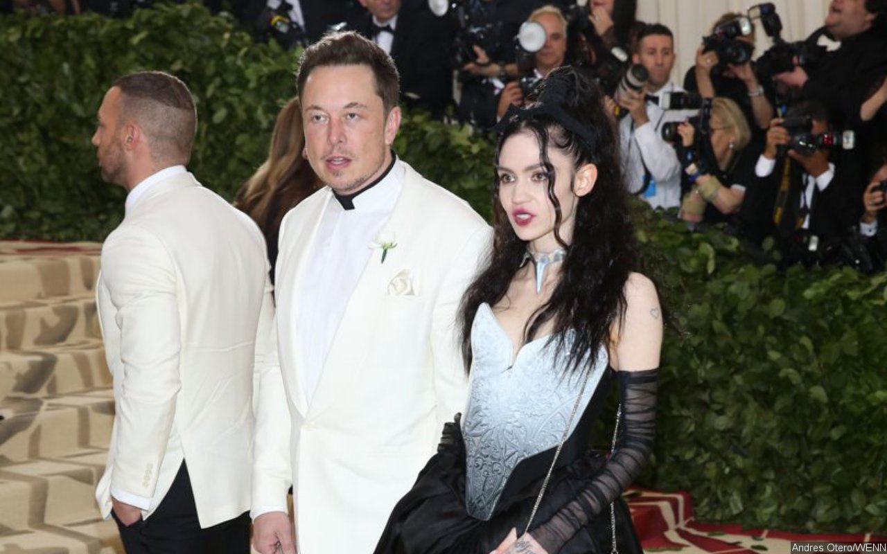 Grimes Confirms She's 'Still Living' With Elon Musk After Trolling Paparazzi With Karl Marx's Book