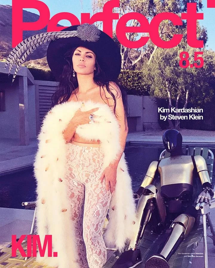 Kim Kardashian poses with Tesla car and robot