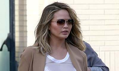 Chrissy Teigen Shows Off Bare Baby Bump in Sheer Crop Top