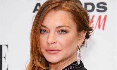 Lindsay Lohan Accidentally Flashes Nipple in Plunging Dress at a Party