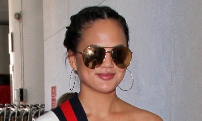 Chrissy Teigen Risks Nip Slip in Nearly-Fall-Off Cardigan at LAX