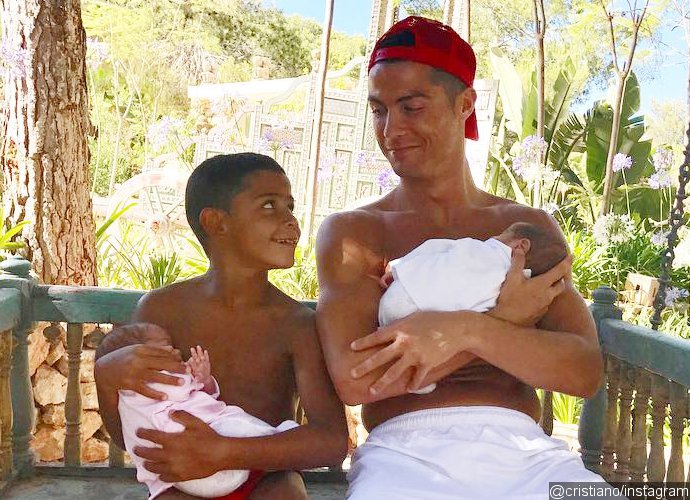 Pic: Cristiano Ronaldo and His Son Cuddling Newborn Twins Is Just Too Cute