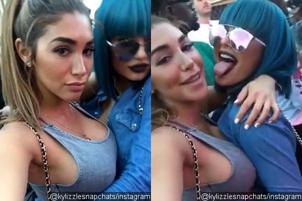 Kylie Jenner Flaunts Butt Cheek in Ripped Denim Shorts While Wearing Blue Wig
