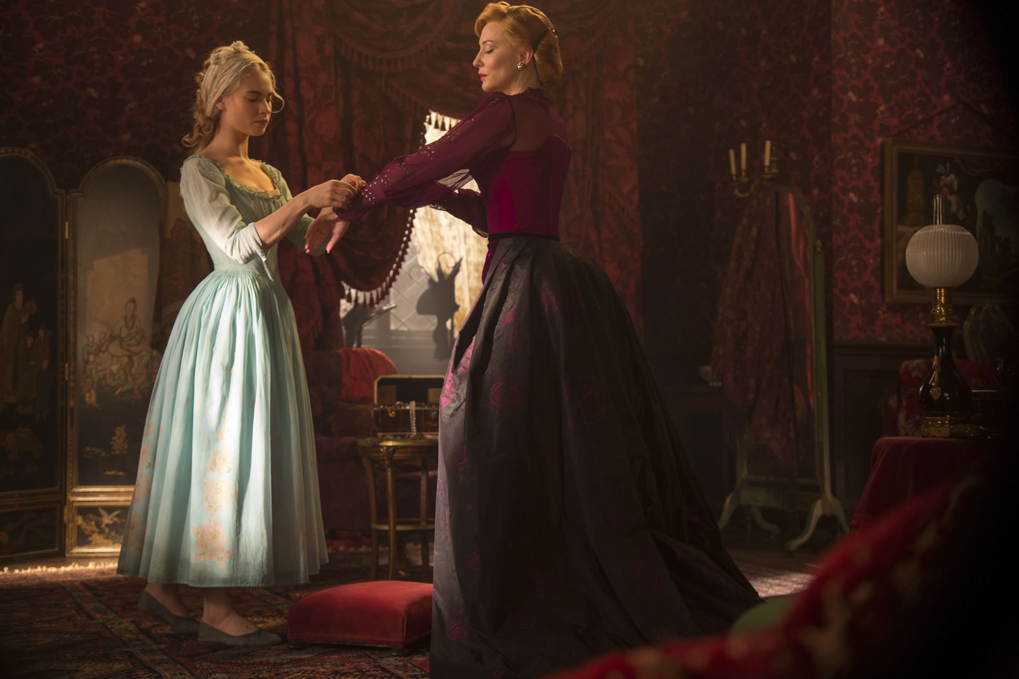 Lily James stars as Cinderella and Cate Blanchett stars as Lady Tremaine in Walt Disney Pictures' Cinderella (2015). Photo credit by Jonathan Olley.