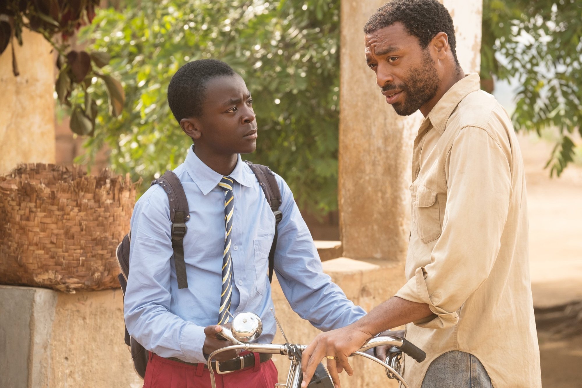 Maxwell Simba stars as William Kamkwamba and Chiwetel Ejiofor stars as Trywell Kamkwamba in Netflix's The Boy Who Harnessed the Wind (2019)