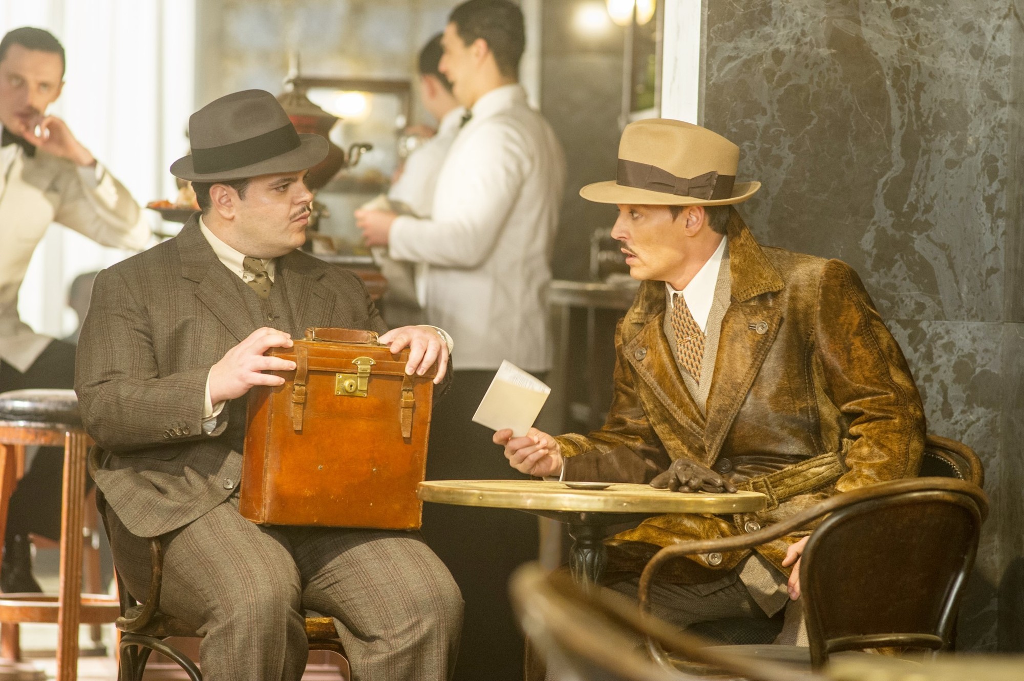 Josh Gad stars as Hector MacQueen and Johnny Depp stars as Ratchett in 20th Century Fox's Murder on the Orient Express (2017)