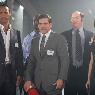 (L-R) The Rock, Steve Carell, David Koechner and Anne Hathaway in Warner Bros Pictures' Get Smart (2008). Photo by Tracy Bennett.