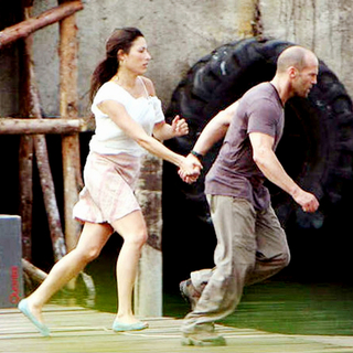 Giselle Itie stars as Sandra and Jason Statham stars as Lee Christmas in Lionsgate Films' The Expendables (2010)