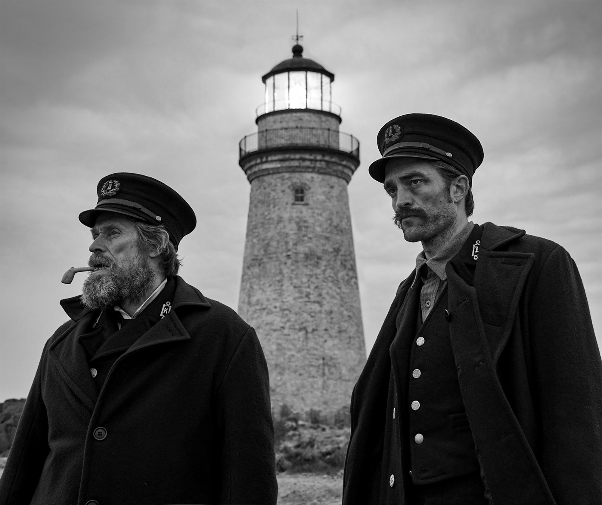 Willem Dafoe stars as Thomas Wake and Robert Pattinson stars as Ephraim Winslow in A24's The Lighthouse (2019)