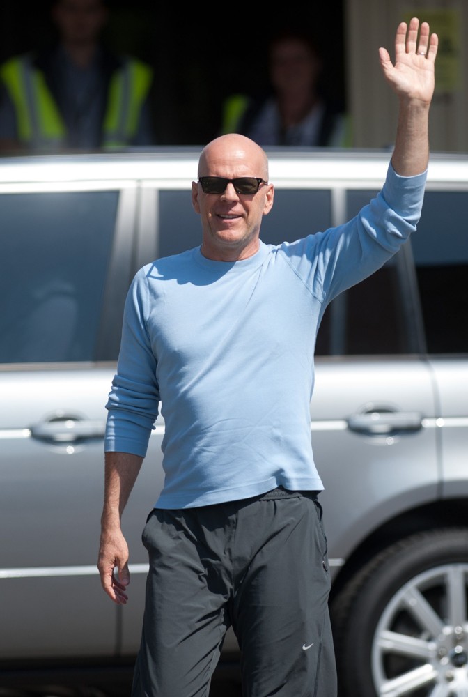 Bruce Willis Waves to Fans at Budapest Airport as He Arrives in The Hungarian Capital