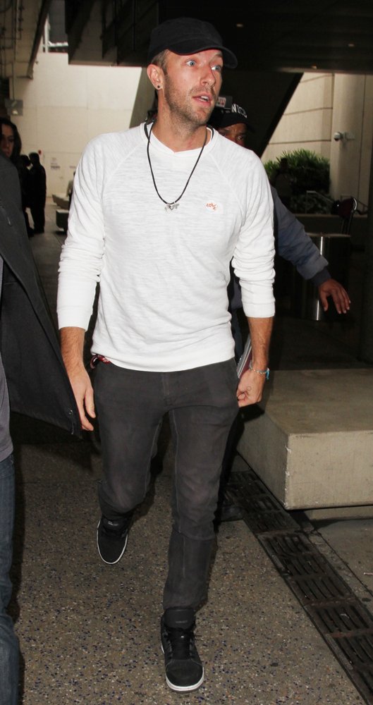 Chris Martin Arrives on A Flight to Los Angeles International Airport