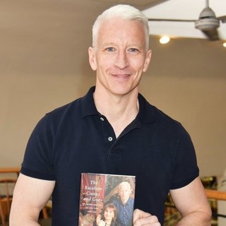 Anderson Cooper Signs Copies of His Book The Rainbow Comes and Goes